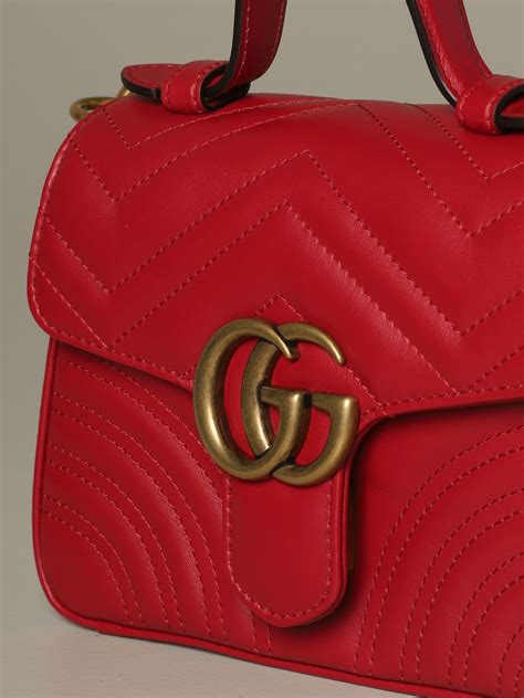 red crossbody gucci bag with pants